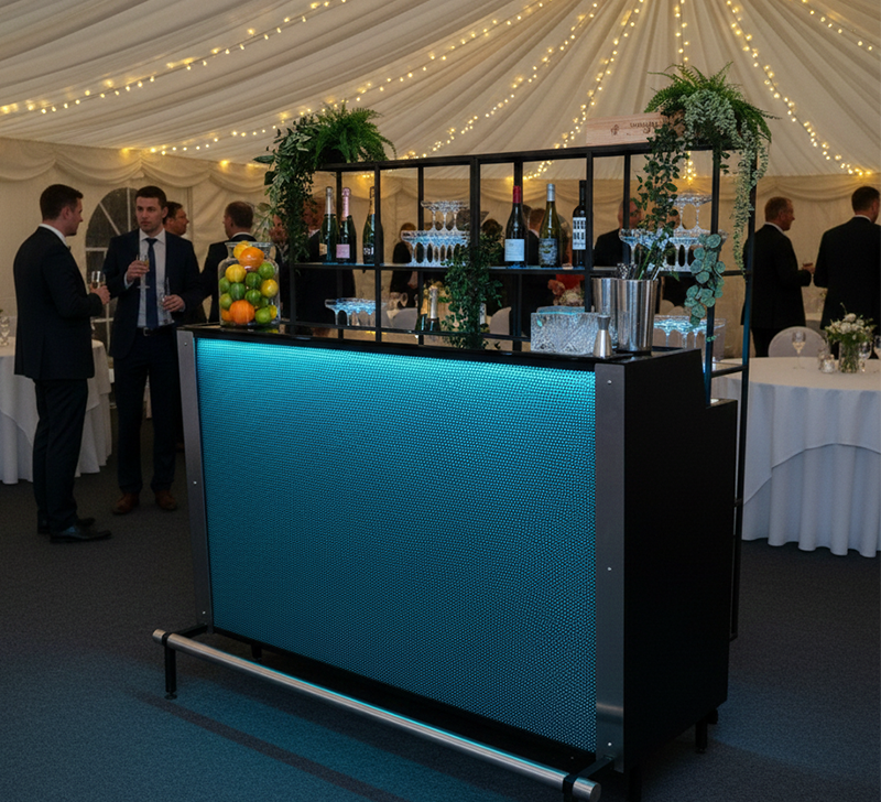 Illuminated bar with guests mingling.